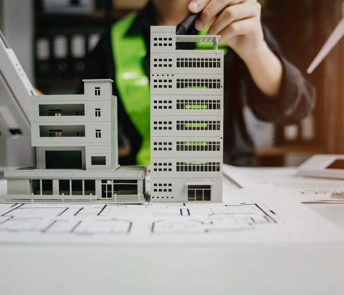 male architect hands making model house. Man architect working i male architect hands making model house. Man architect working in the office.