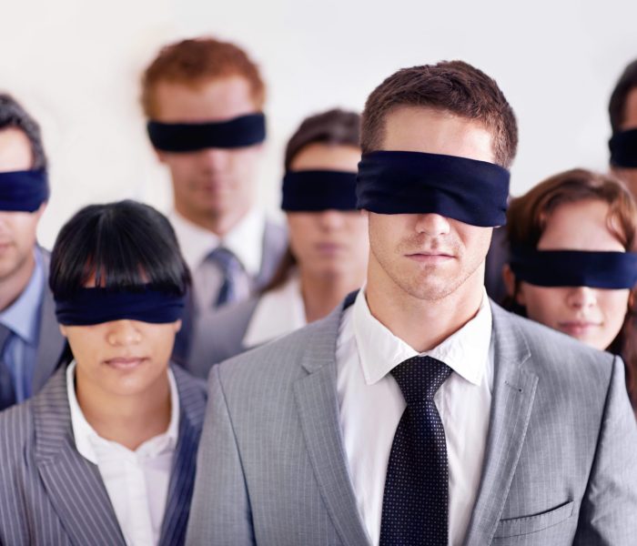 Shot of a group of businesspeople all wearing blinfolds.